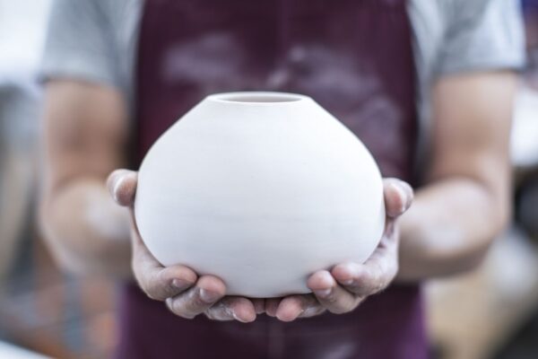 hands-of-male-potter-holding-finished-vase-in-workshop-665479463-596284a15f9b583f180d5a3c